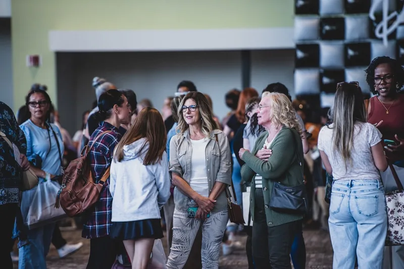 Women gathering and talking in the conference lobby